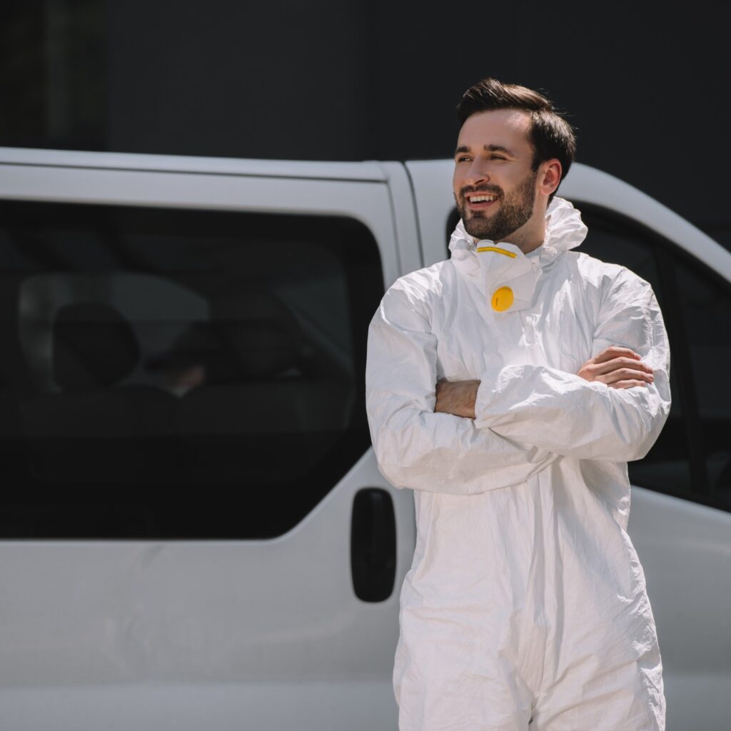 smiling pest control worker in uniform standing wi 3jc2gud.jpg